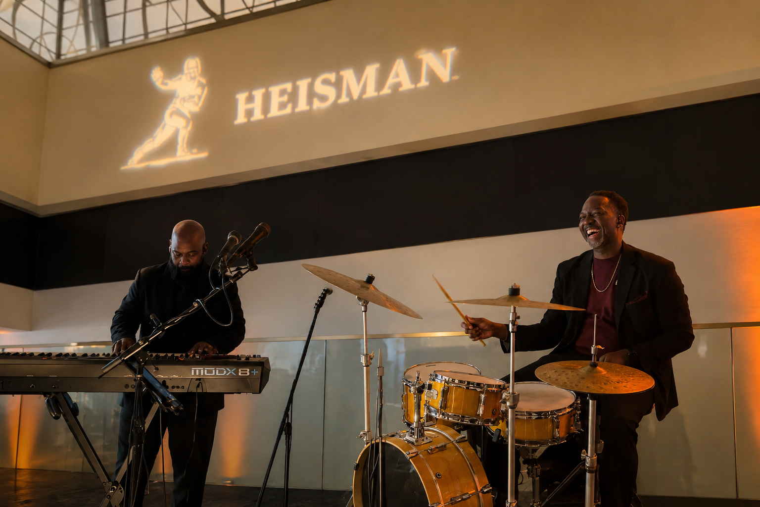 Keyboard and drums duo performing beneath the Heisman logo, Times Square NYC