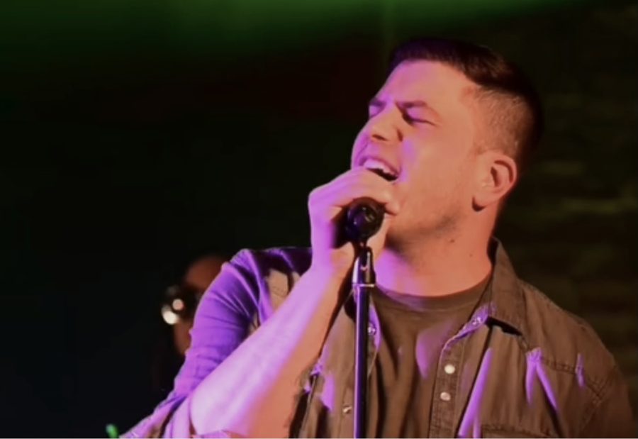 Singer performing under stage lights
